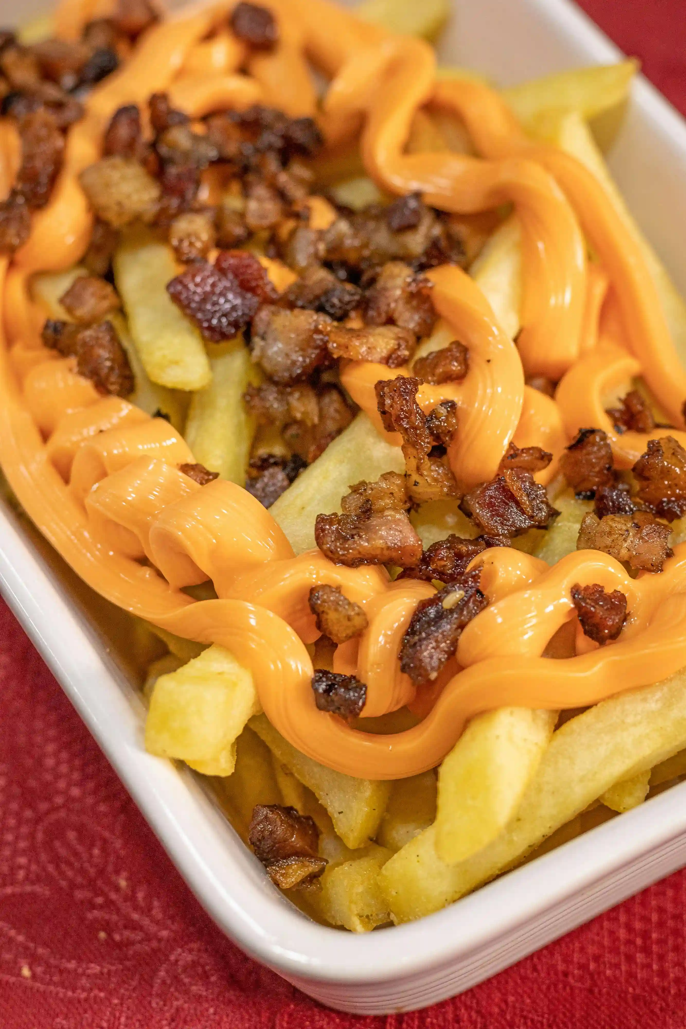 picture of a bacon cheese fries on a plastic takeout container